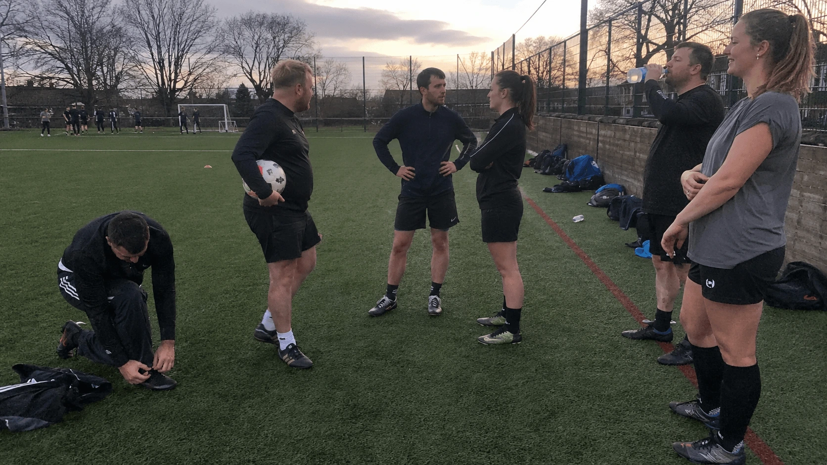 Local football club members talking after a session