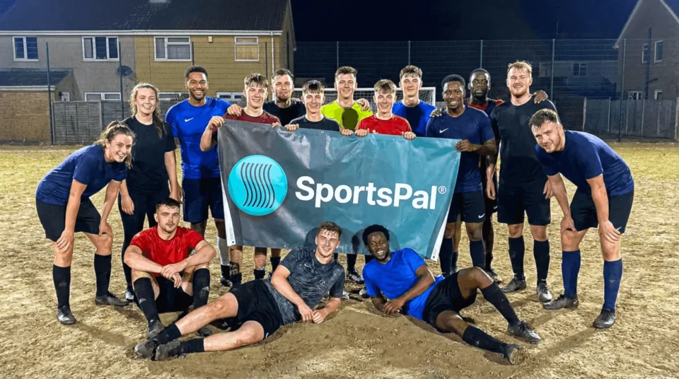 Football players holding the SportsPal banner after their game